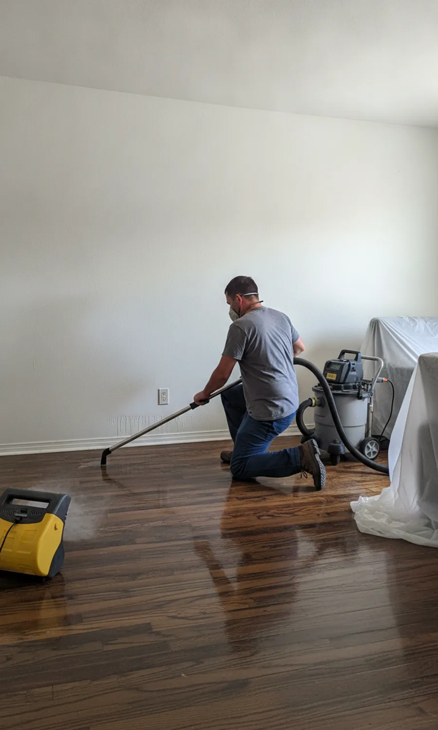 Water damage restoration technician extracting water in a Glendale, CA home